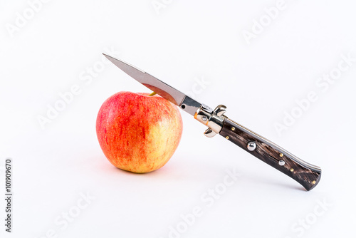 Принти на полотні Italian switchblade knife and red apple.