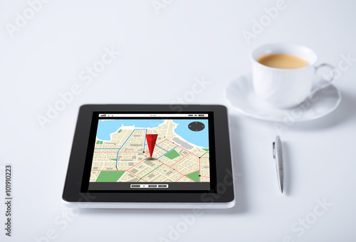 tablet pc with gps navigator map and cup of coffee