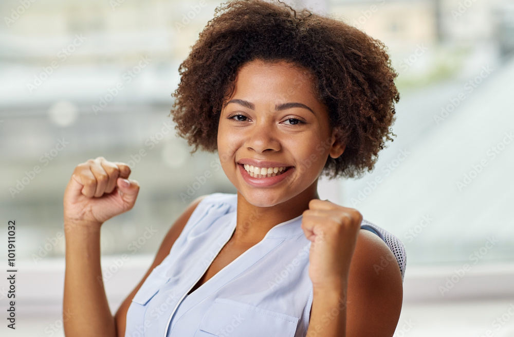 happy african young woman with raised fists happy african young woman with raised fists