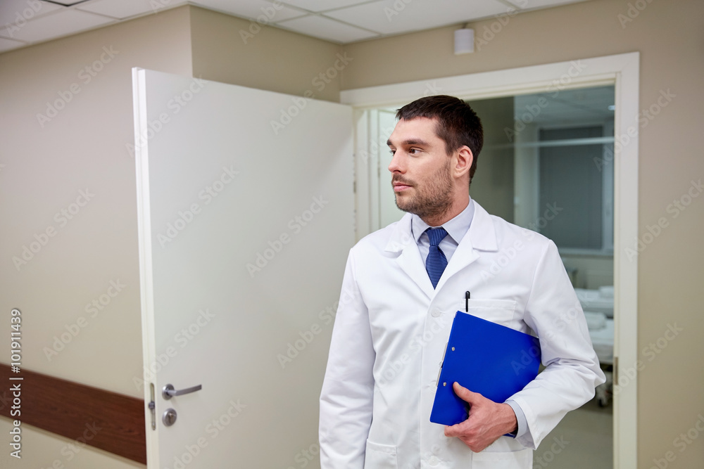 doctor with clipboard at hospital corridor