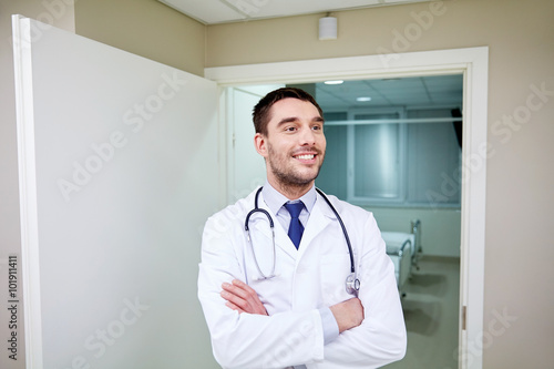 smiling doctor with stethoscope at hospital 