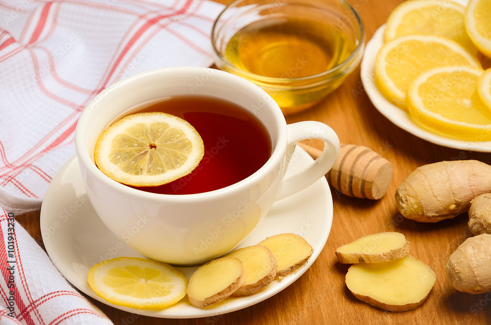 Black tea with lemon, ginger and honey on the wooden table. Horizontal permission. Selective focus. Black tea with lemon, ginger and honey on the wooden table. Horizontal permission. Selective focus.
