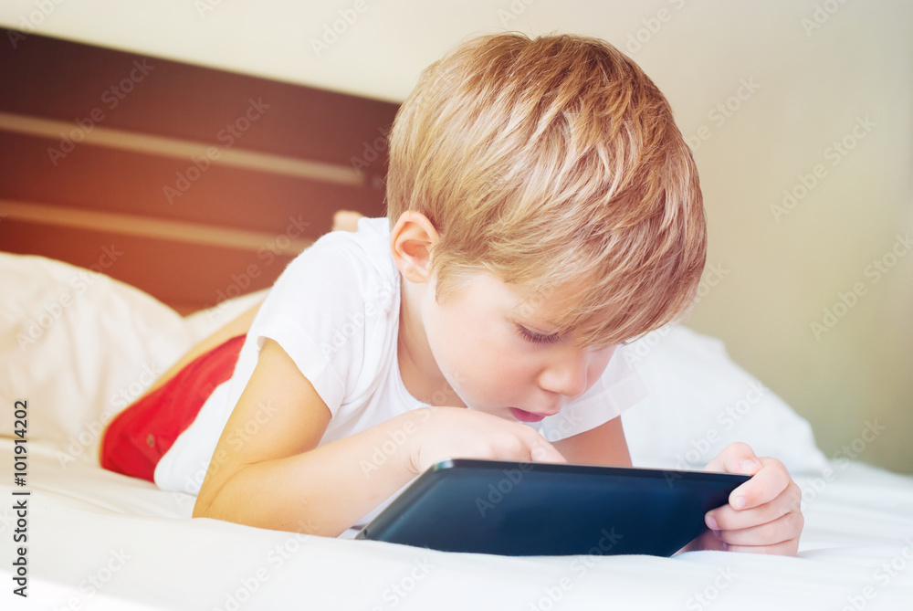 Child plays games on tablet. modern technologies Child plays games on tablet. modern technologies