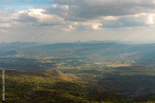 Scenic top view on the mountains on cloudy summer day. © chanwitohm