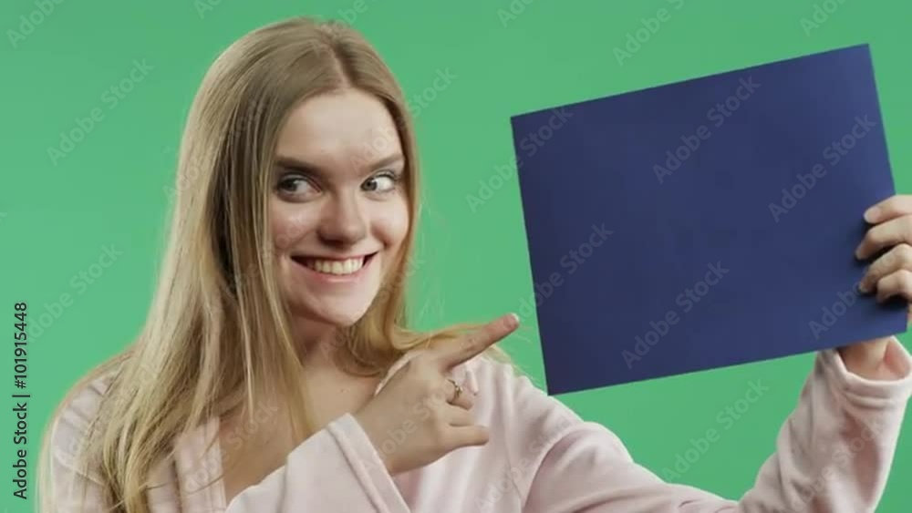 girl with a blue sign on a green background girl with a blue sign on a green background