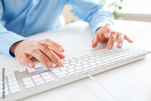 Men office worker typing on the keyboard