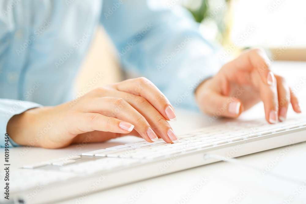 Woman office worker typing on the keyboard Woman office worker typing on the keyboard