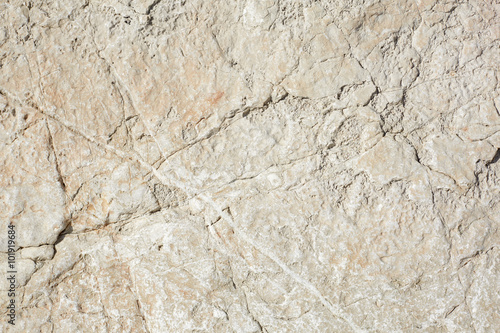 Warm white stone texture background in sunlight