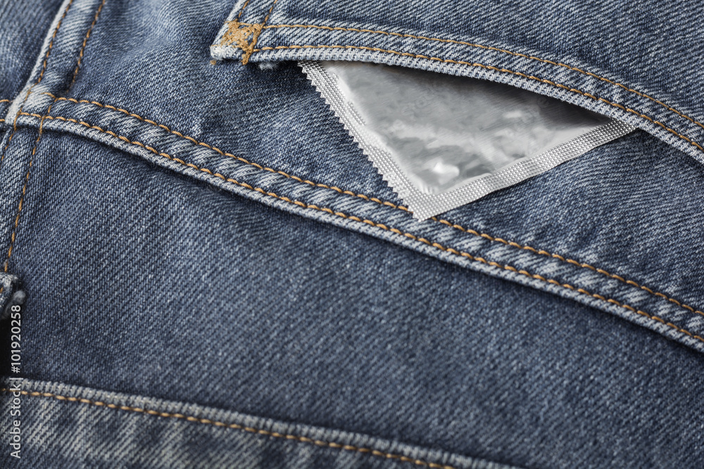 Condom in blue jeans pocket.