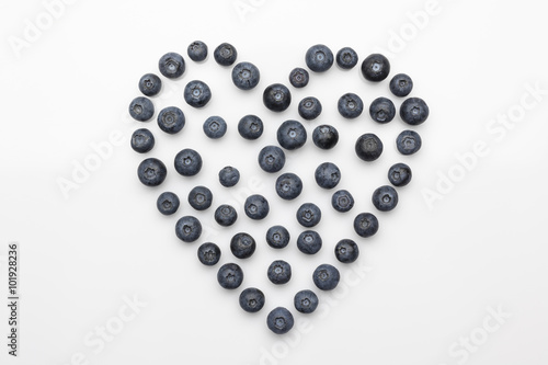 Blueberries heart in a centre on white background directly from above