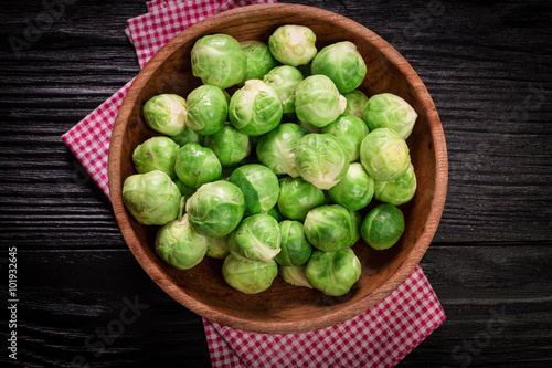 Fresh brussel sprouts over rustic wooden texture.healthy food