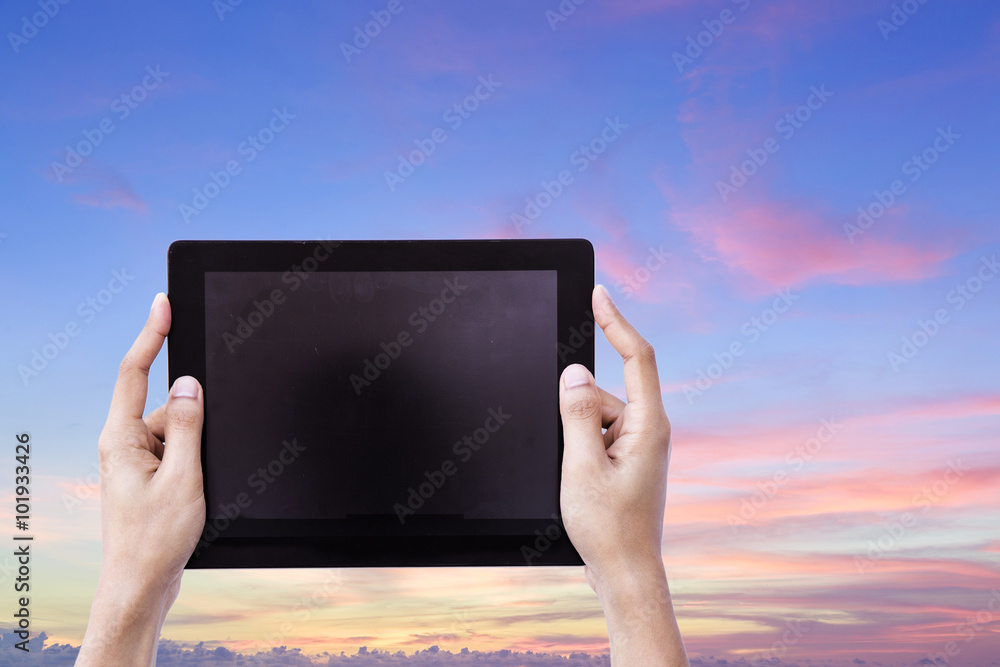 Female Hands Hoding Tablet with Bueatiful sunset sky