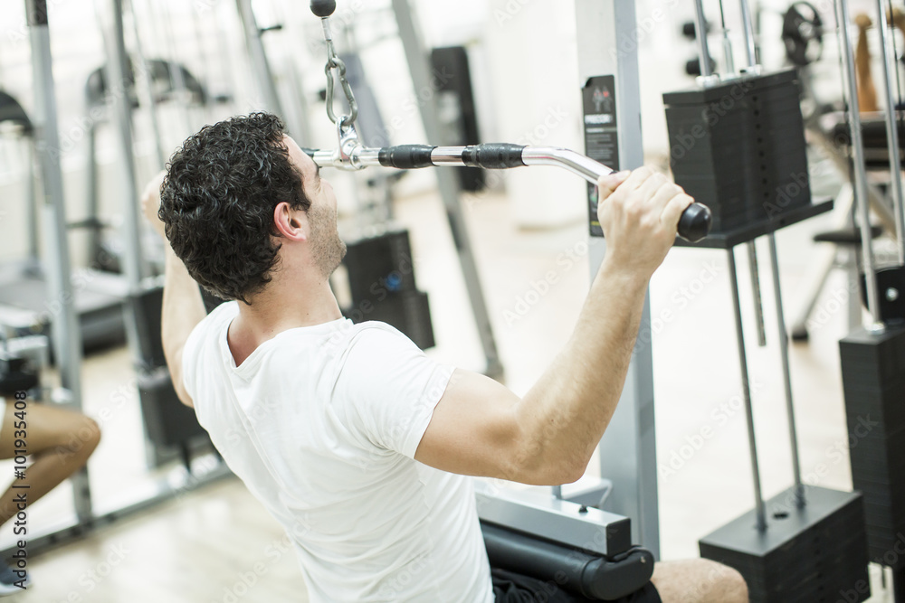 Fototapeta premium Young man training in the gym