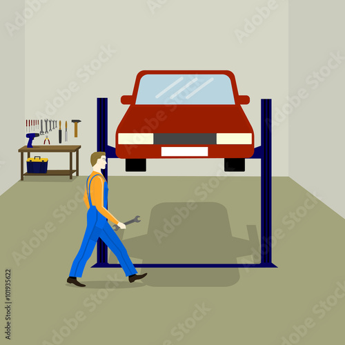 the mechanic repairs the car in the service station. table with work tools, tool box, auto lift for car