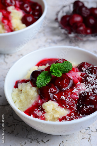 Rice Pudding with Cherry Sauce on white background