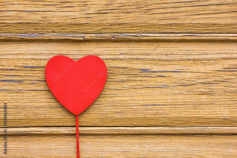 Red wooden heart on yellow wooden desk background. Red wooden heart on yellow wooden desk background.