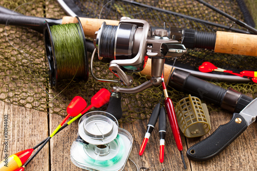 fishing tackle on a wooden table. toned image 