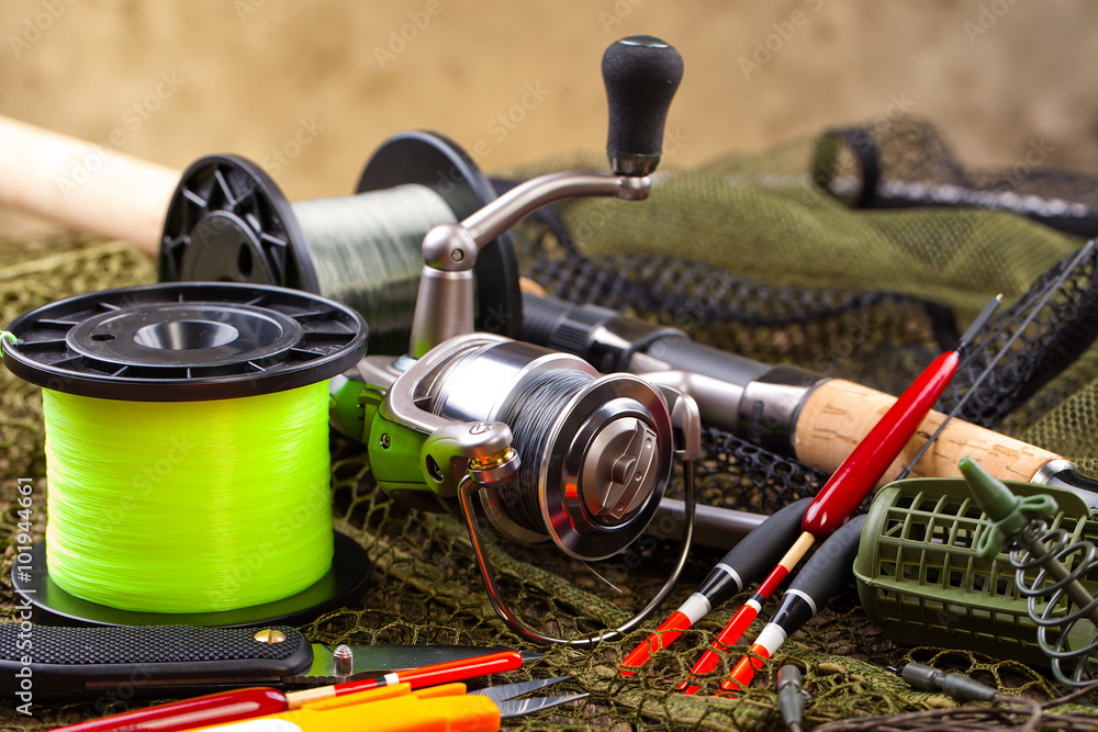 fishing tackle on a wooden table. toned image
