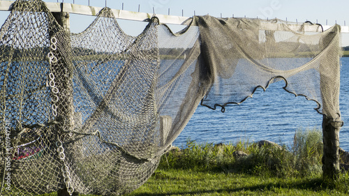 Fishing nets and fish traps on drying on a wooden rack.