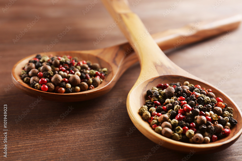 Two wooden spoons with pepper on the table, close-up Two wooden spoons with pepper on the table, close-up