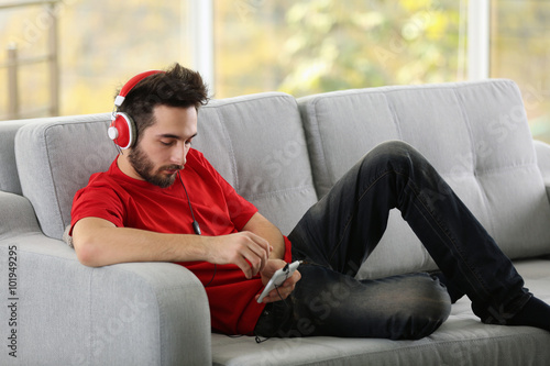 Handsome man listens music ...