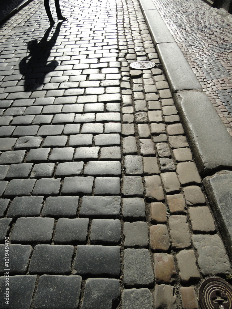 Obraz premium Paved Road With A Human Shadow
