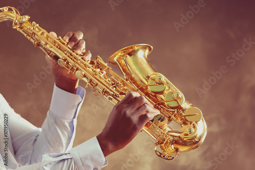 Photography African American jazz musician playing the saxophone, closeup