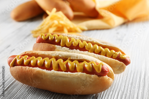 фотографія Hot dogs with cheese on wooden background