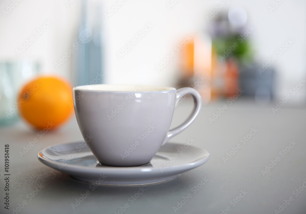 Cup of coffee on the table against unfocused background Cup of coffee on the table against unfocused background