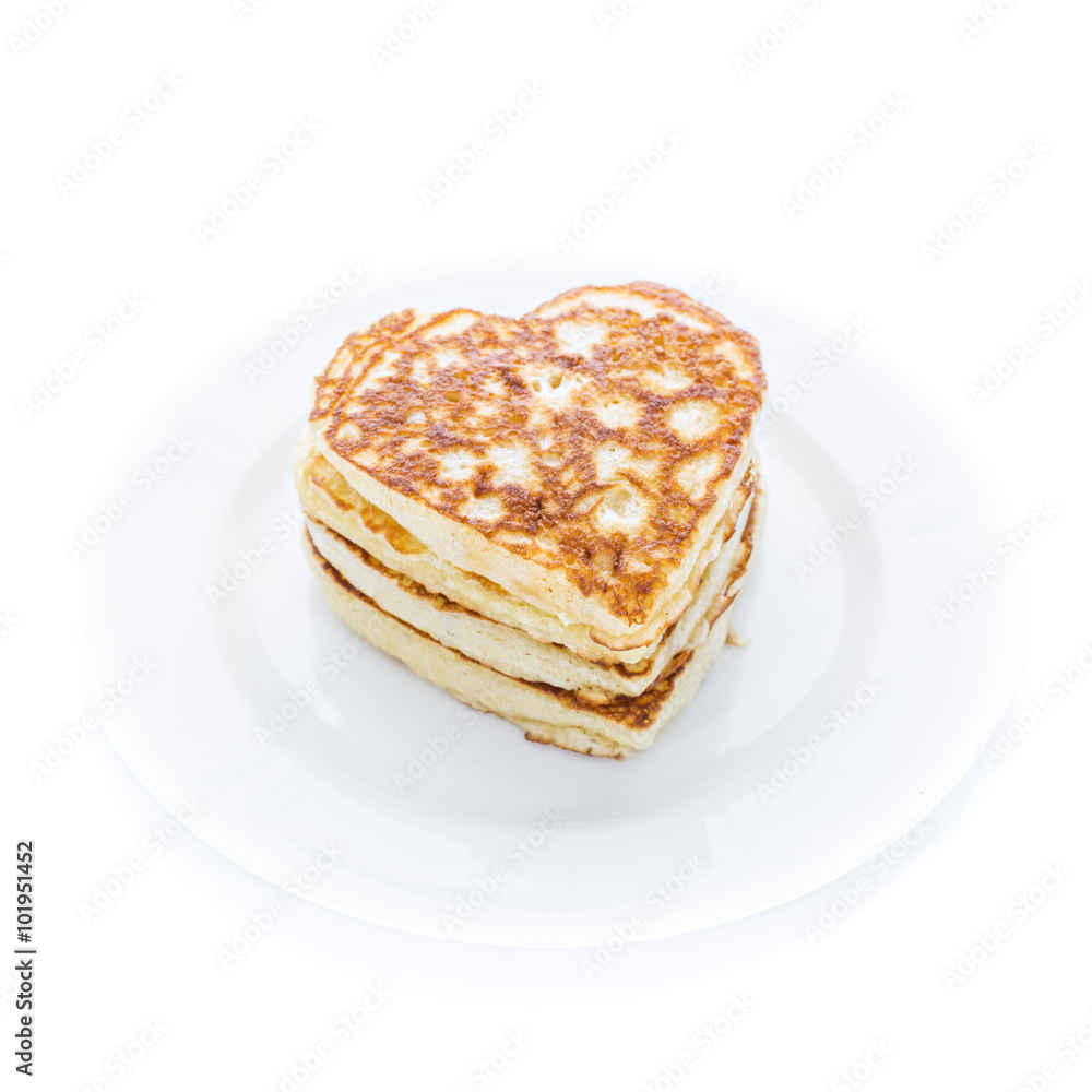 Pile of heart shaped pancakes on white plate Pile of heart shaped pancakes on white plate