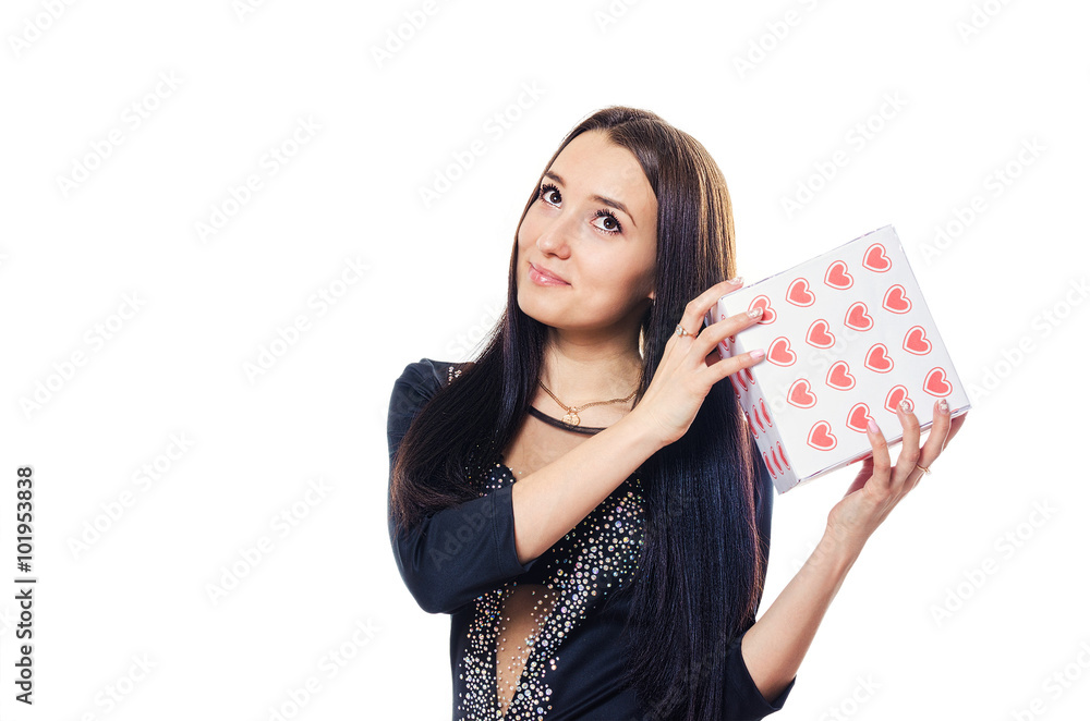 The girl holds a gift in hand