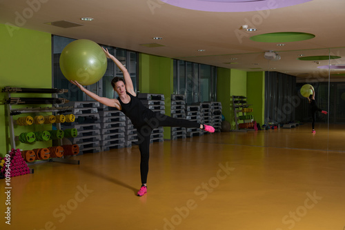 Woman Working Out With Ball In The Gym