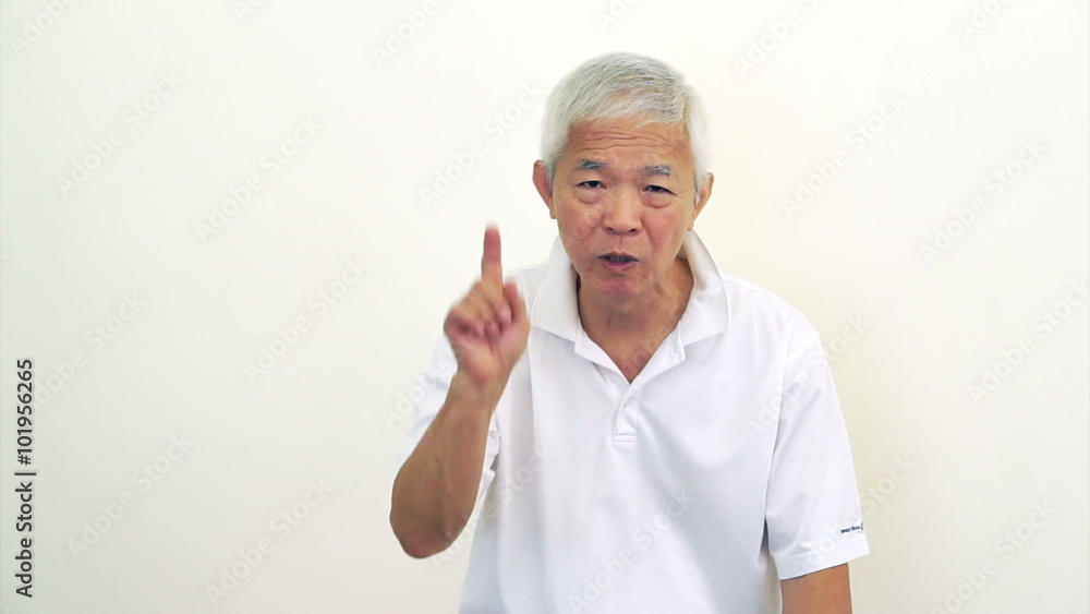 Asian man Senior looks at camera shakes head and do hand gesture to decline, says no Asian man Senior looks at camera shakes head and do hand gesture to decline, says no