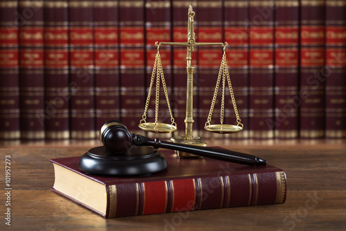 Mallet And Legal Book With Justice Scale On Table photo