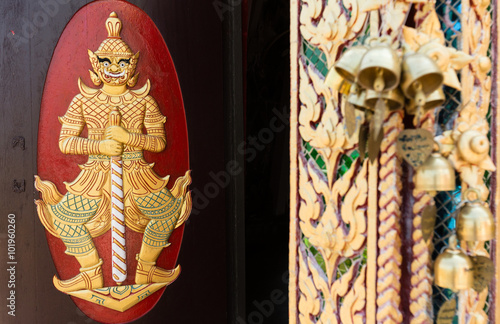 Wood carvings, gold giant on a red background in temple ,Thailand. this  is public carving so no need properties release.