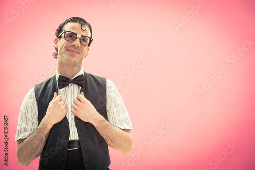 Happy nerd man with glasses think portrait on pink photo