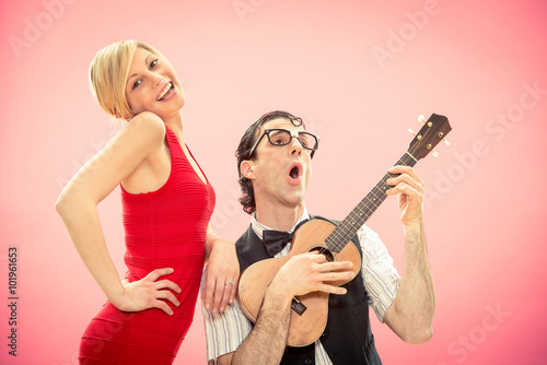 Nerd man boyfriend play ukulele love song for his girlfriend for valentine day © ZoneCreative
