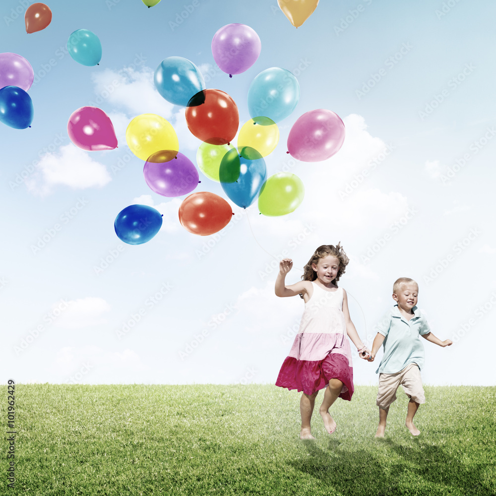 Little Girl and Boy Outdoors Holding Balloons Concept