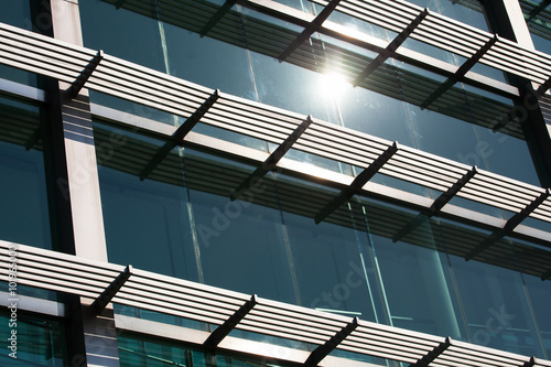 Close-up of glass building with windows reflected to the sky © twinsterphoto