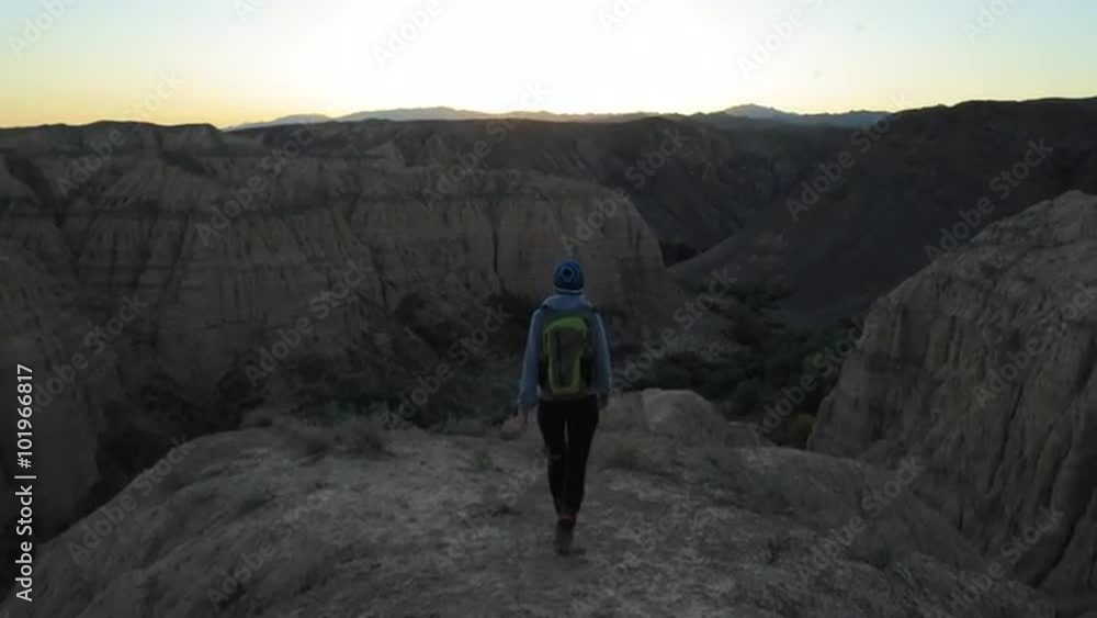 Young girl walking through the Canyons at sunset Young girl walking through the Canyons at sunset