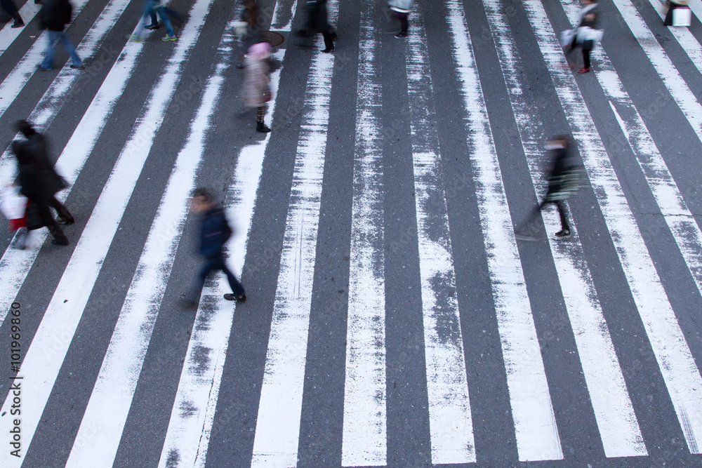 Blurred Pedestrians Rushing Across Crosswalk