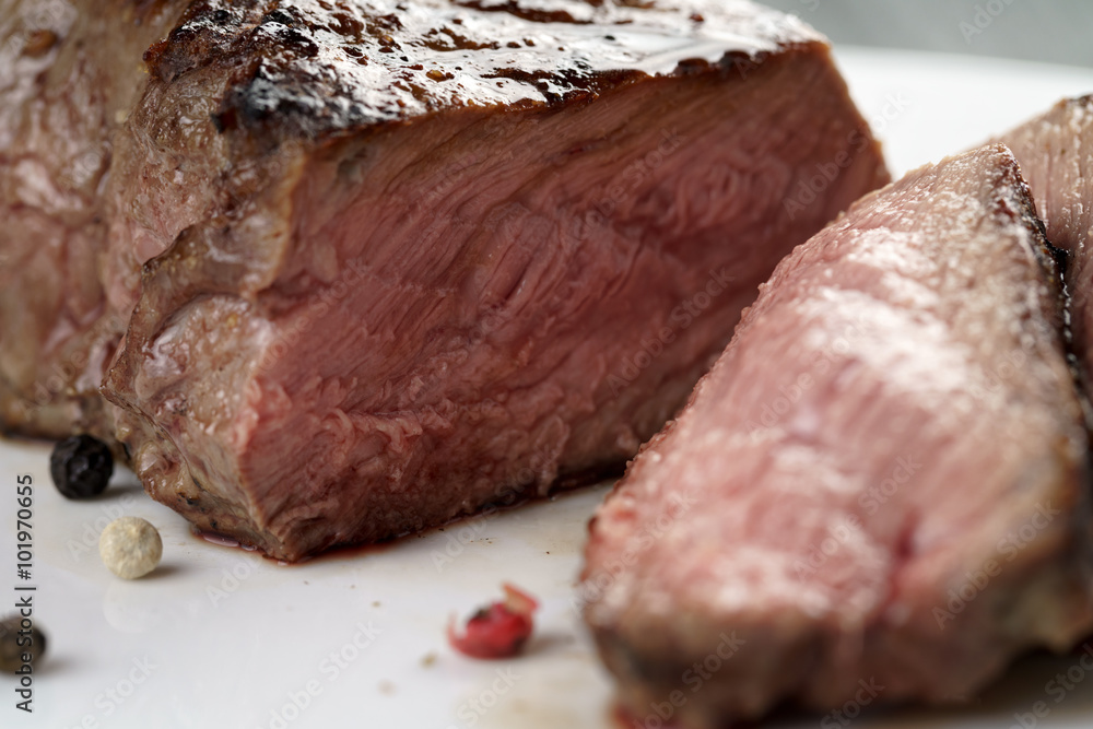 sliced beef steak on white plate close up sliced beef steak on white plate close up