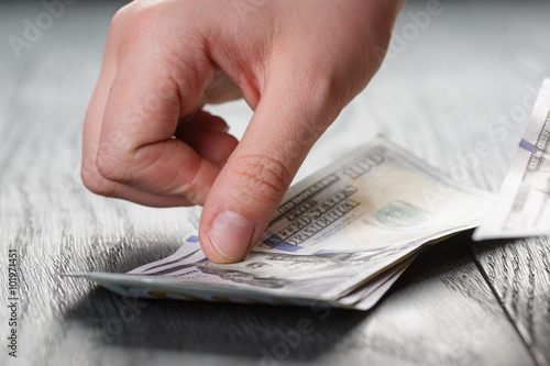 Wallpaper Mural young female hands count dollar bills on wood table Torontodigital.ca