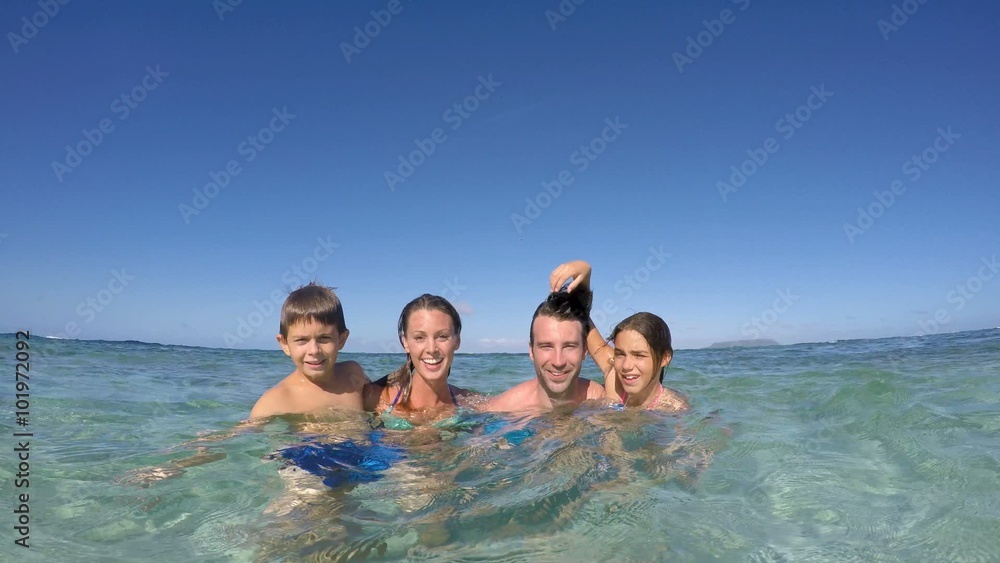 Happy family enjoying swimming in caribbean sea Happy family enjoying swimming in caribbean sea