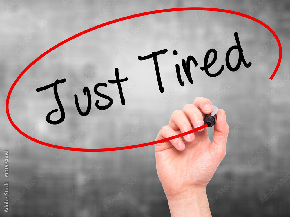 Man Hand writing Just Tired with black marker on visual screen. Man Hand writing Just Tired with black marker on visual screen.