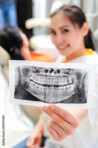 Dentist looking at x-ray picture photo