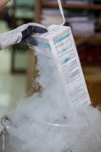 Technician removing specimens from freezer