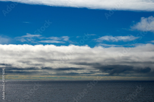Seascape with blue sky and white clouds