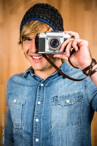 Smiling hipster man taking picture