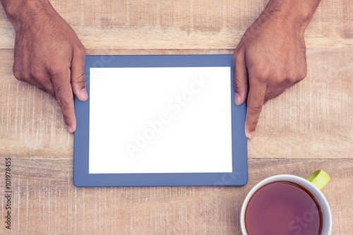 Directly above shot of man holding on digital tablet